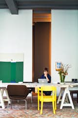 Office, Desk, and Chair With the help of architect Bart Lens, Veerle Wenes and Bob Christiaens merged a 19th-century building with a 1970s one to create a combined home and art gallery in Antwerp. In the dining room downstairs, Wenes entertains family, friends, and gallery visitors. The yellow chair is by Jens Fager.  Search “feast house simon dining table” from This House Proves Art Galleries Can Be Super-Friendly