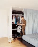 To make the bedroom seem ethereal—and far larger than its 12-by-12 dimensions suggest—Pratt designed a curtain that hangs on three sides, hiding closets to the left and right of the bed and providing privacy when extended in front of the sliding glass doors. The bedspread, in charcoal with undulating turquoise stitching (www.foldbedding.com), recalls the folds of the curtain; the overall effect is of a place for floating off to sleep.