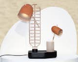 To turn the Standard lamp on, users must move one of three fixtures into the light's copper base.