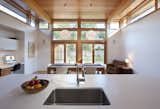 The owners requested that the kitchen act as the center of the home so it was built at the rear of the property. "It allowed us to pop off the roof and add clerestory windows to bring in an abundance of sunlight and fresh air," DiRocco said. The sink is by Blanco and the faucet is by Grohe.