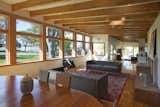 Fir laminate decking ceilings run perpendicular to exposed beams in the dining and living rooms.