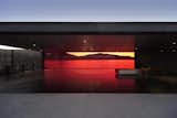 “We think of architecture as a tool that manipulates human perception,” Bailey says. He uses the opaque portions of the building to block the least essential elements of the vista, framing the northern exposure with vibrant crimson glass.  Photo 5 of 10 in A Dramatic Viewing Platform in Tasmania by Diana Budds