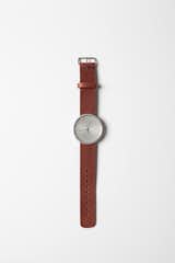Aluminum W1 watch with a leather strap.