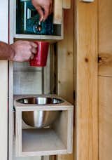 One corner holds a refillable water jug and a stainless-steel washbasin.  Photo 6 of 10 in Camping with Dad Just Got Cooler