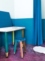The pencil-themed desk and stool are by Pierre Sala.