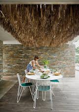 The Mourtzouchoses entertain constantly, which means that food is rarely far from anyone’s mind. Alexia sets a Tio table (with matching chairs) by Massproductions, over which hangs a thatch of dried palm fronds.  Photo 7 of 13 in An Idyllic Vacation Home in Greece