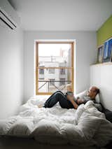 The bed takes up nearly the entire master bedroom, but it doesn’t make the space feel cramped. The wide window keeps the tiny box light.  Photo 7 of 14 in A Storage-Smart Renovation in New York City