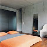Bedroom, Bed, Medium Hardwood Floor, and Chair The master bedroom is spartan.  Photo 10 of 11 in Swiss Mix