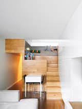 Staircase and Wood Tread Of the seven steps in Michael Pozner’s not-quite-500-square-foot aerie in Greenwich Village, five contain drawers. His small set of table and chairs is from CB2.  Photo 3 of 12 in The Manhattan Transformation