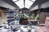 The mezzanine above the bar features another Shadowy chair from Moroso, a vintage bar cart and a bench upcycled by Out of the Dark.  Search “www.kmovie.club” from Lush Interiors for London's Elite New Design Club