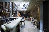 Another view of the bar, showcasing the recycled-glass bar top. Designer Chris Duffy made the bar tables against the wall.  Luis Tágano’s Saves from Lush Interiors for London's Elite New Design Club