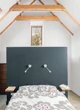 Bedroom, Bed, and Wall Lighting Designer Sue Macintosh chose the Farrow & Ball Off-Black paint for the master bedroom.  Search “solar inspiration” from This Farmhouse is a Cor-Ten Steel-Clad Dream