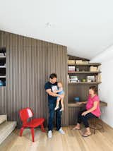 Office, Chair, Desk, Shelves, and Light Hardwood Floor Iason Vassiliou, Maria Voutsina, and their daughter, Angeliki, relax in a landing-level office at their apartment in Athens, Greece.  Search “The-Penthouse-Has-Landed.html” from Odd Angles Don't Stop This Apartment's Transformation