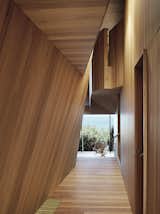 The house that architect John Wardle designed for a couple in coastal Fairhaven, Australia, twists and bends to comply with local laws that prevent buildings from disrupting the ridgeline views from the Great Ocean Road.  Photo 2 of 9 in A Eucalyptus-Lined Oceanfront Home in Australia