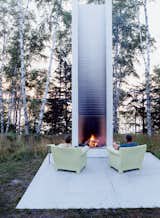 Outdoor, Small, Concrete, Trees, Grass, and Back Yard Philippe Starck’s outdoor chairs for Kartell provide cozy fireside seating. These and the sofa version were selected by Salmela. “They’re very much an art form,” he says.  Outdoor Trees Small Back Yard Photos from Off the Beaten Path