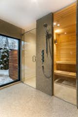 Bath Room and Enclosed Shower The renovated house is outfitted with a sauna.  Photo 9 of 10 in 10 Sterling Saunas in Modern Homes from Near Montreal, a 1950s House Gets a Modern Makeover