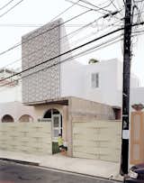 With an eye for a Caribbean lifestyle that incorporates wind, water, and sunlight, architect Nataniel Fúster renovated an existing 1940s home in San Juan. The modern take on tropical style uses a mixture of hammered, exposed concrete at the base of the home, which gives way to perforated-concrete panels and the bright white of the rest of the concrete facade. The perforations and white exterior keep the home cool through natural ventilation. They also refract and reflect the sunlight.