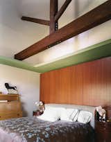 The Suarezes opted for a cozy bedroom with beautiful details, old and new—lustrous mahogany behind the bed, Baker tables beside it. The long beam overhead replaced the original, but smaller beams above it are authentic.