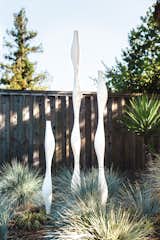Outdoor, Shrubs, Gardens, Vertical Fences, Wall, Wood Fences, Wall, Garden, and Trees Tall Stacks

In reworking the landscape, Neely added 1950s ceramic sculptures by Malcolm Leland, who calls them “modern totem poles.”  Photos from Modern Furniture Fit for a Classic Eichler