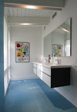 Another one of the home's light-filled spaces, the bathroom includes Wetstyle sinks and blue tiling. Photo courtesy of the owners.  Photo 7 of 14 in Bathrooms by Elaine & Russ from A Mid-Century Modern Renovation in Palm Beach County