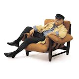 We’ll start with the captain: Sergio Rodrigues, who was born in Rio de Janeiro in 1927, sits in his Mole chair, designed in 1961 and identifiable by its generous arm padding.