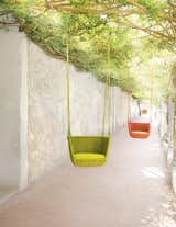 Adagio suspended seat by Francesco Rota for Paola Lenti, shown on the grounds of Jack Lenor Larsen's LongHouse Reserve in East Hampton, New York.  Search “doorsdoor-type--swing” from Outdoor Furniture Exhibition at Jack Lenor Larsen's LongHouse