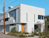 The glass staircase figures prominently in the facade, but Don designed the windows to ensure privacy. Using computer models, he conducted visual studies to suss out sight lines from the street. “People can’t see in, but we still get light.”  Photo 1 of 9 in A Minimalist Duplex in Venice, California