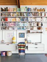 Living Room, Chair, and Shelves A 606 Universal Shelving System by Dieter Rams for Vitsœ dominates one end of the living room.  Photo 6 of 7 in Shelving Solutions for Bookworms by Brandi Andres from A Midcentury Home Keeps the History Alive
