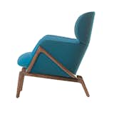 Elysia lounge chair by Luca Nichetto for De La Espada. A frame in solid American black walnut or European ash hugs a padded seat and backrest. Fabric upholstery options include blue, red, and dove gray. Picture courtesy of De La Espada.