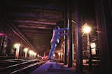 Graffiti artist standing on a wood covering over the third rail. Photo courtesy Matt Litwack.  Photo 2 of 10 in Beneath the Streets: Photos of New York’s Secret Underground