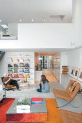 Hernandez and Surratt relax in the living room, which is enlivened by the house’s internal topography. A short flight of steps divides the interconnected areas and offers a place to sit. Above is a loft that can be converted to a bedroom.