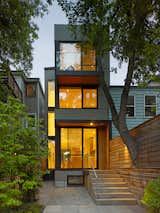 The narrow Marlborough House, situated on an infill lot in Toronto, features a three-story void in the center that lets light into the interior rooms.