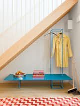 Staircase Furniture with emphasized linear elements helps prevent the appearance of clutter in small spaces. It's particularly effective when highlighted in playful colors like the blue bench storage rack in this London guesthouse. Photo by Ben Anders.  Photo 13 of 16 in How to Design with Blue by Diana Budds from A Colorful, Custom-Built Guesthouse in London
