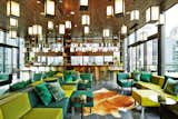 The rooftop bar features custom green sofas and lanterns by Concrete meant to replicate an urban garden. "Every great spot in New York has a rooftop bar," Vermeulen says. Photo by Adrian Gaut.  Photo 6 of 6 in Bright Hotel with Spacious Communal Lobby in Times Square by Allie Weiss