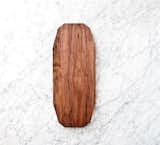 The Ray Long Board is characterized by its use of geometric shapes and angles. Designed to present bread, cheeses, charcuterie, and other small appetizers, the board features beveled edges that make it easy to pick it up off of the table. The top of the board is etched with a series of lines, which create a graphic visual statement of angles and intricate shapes.