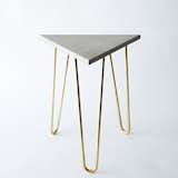 Zelda Table by Brooklyn-based designer Katy Skelton. This refined industrial table is made of solid brass hairpin legs paired with an engineered concrete top.