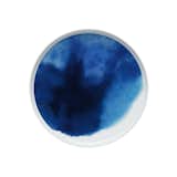 Featuring a graphic print designed by Aino-Maija Metsola, this large plate from Marimekko presents a stunning visual that looks like a watercolor painting. The plate features a varied blue color scheme, reminiscent of water and clouds.
