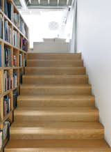 The adjacent extra-wide stairs provide easily accessible storage space; the custom bookcases, made of the same Douglas fir plywood as the treads, follow the rise of the steps to the bedroom.