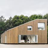 WFH House (Wuxi, China)

Copenhagen-based Arcgency made something special out of a rigid skeleton of shipping containers—a gorgeous, bamboo-clad modular home that offers stylish customization options and environmental features (solar cells, water cistern, green roof) that push this project beyond mere recycling. 

Photo by Arcgenvy