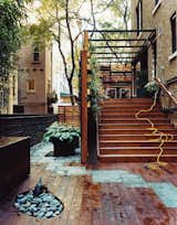A living wall, expertly located potted plants, and a mixture of paving materials bring a designer's eye to this formerly desolate, narrow rear yard in Manhattan's Upper West Side. The wooden planters and English ivy also provide privacy from the neighbors and help keep out noise without blocking light.