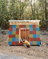 The patchwork panels of this shed were culled from leftover siding and materials from the construction of the main house, a rural retreat designed by Resolution: 4 Architecture.