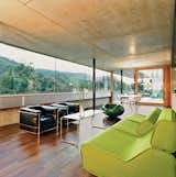 After walking through the front door visitors enter directly into the enormous kitchen and living space. The interior is minimal, using predominantly timber and concrete. It also provides some spectacular views of the river.