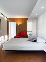 The bedroom is a comfortable show of geometric regularity.  Photo 11 of 11 in Massie Produced