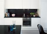 Laminated-MDF cabinetry helps to hide clutter in the kitchen.