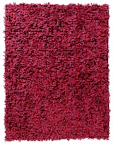 The completed rug is wildly textured with felt blossoms, which are the three-dimensional representations of patterns inspired by Boontje's sketches.