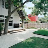 Outdoor, Grass, and Walkways Dollahite’s house sits on a tree-lined block in the north Austin neighborhood of Hyde Park. His remodel retained the old Texas feel of the exterior, with modern touches inside.  Photo 11 of 12 in 12 Porches Across America by Diana Budds from Salvage Love