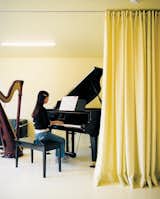 Musical accompaniment to daily life is provided by the children, both of whom play the grand piano.  Photo 5 of 5 in Rooms Designed For Music by Zach Edelson from Magic Mountain