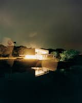At night, the entire studio glows like a lantern, its light amplified by the reflection in the seasonal pond. I