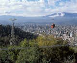 The city’s second highest point, Cerro San Cristobal, with its Swiss-style gondolas, 

rises some 1,000 feet above the rest of the city and is where Santiaguinos escape the urban bustle to picnic, swim, hike, and wander through gardens. Metropolitan Zoo 

is at the base of the towering hill.