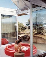 Outdoor, Small, and Desert The living space and bedrooms are separated by two small courtyards. Linda Taalman reclines in a small, inflatable wading pool in the home's "firecourt," facing south toward the desert.  Outdoor Desert Small Photos from iT House, Joshua Tree